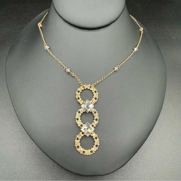 Belladonna Circular Crystal and Gold Tone Infinity Pendant Necklace - Picture 3 of 17